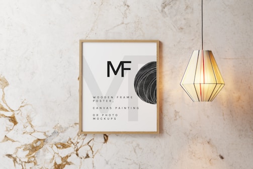 A minimalistic gold-accented framed blessing print on a clean white wall.