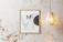 A cozy living room wall adorned with a minimalist printable art from Frame Gallerina.