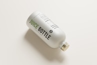 a bottle of juice on a white surface