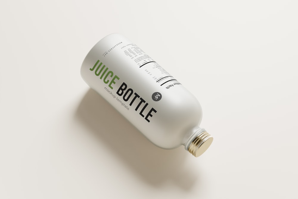a bottle of juice on a white surface