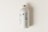 A minimalist juice bottle featuring a white label with nutritional facts and branding. The label includes the words 'Juice Bottle' in bold, with contrasting green and black text. The bottle has a metallic screw cap and is placed on a light, neutral background.