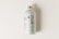 A minimalist juice bottle featuring a white label with nutritional facts and branding. The label includes the words 'Juice Bottle' in bold, with contrasting green and black text. The bottle has a metallic screw cap and is placed on a light, neutral background.