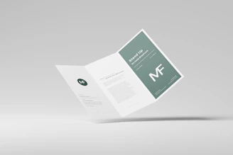 a folded brochure with a green and white design