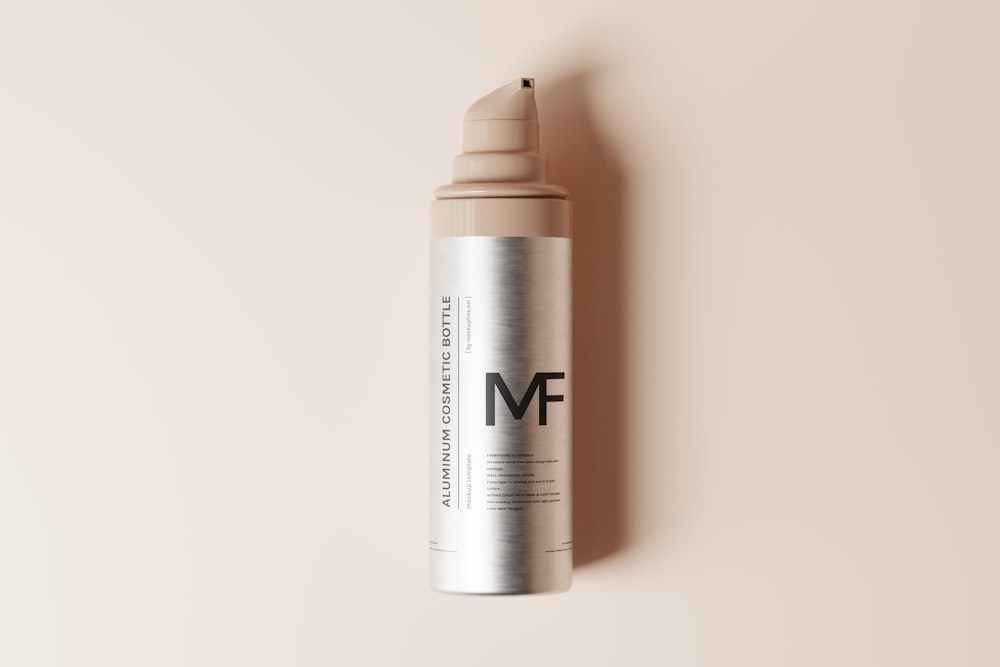a bottle of m f cosmetics on a pink background