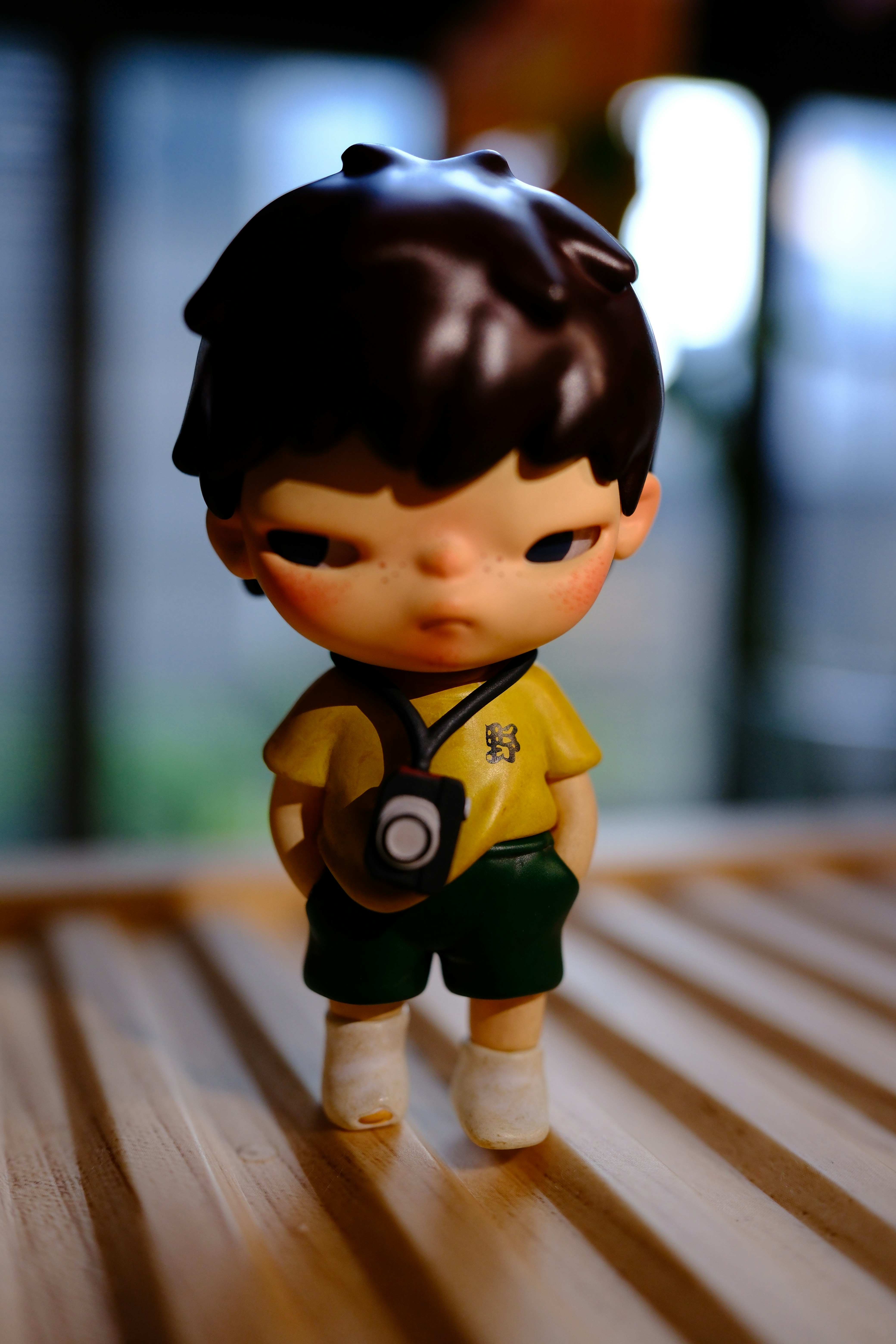 a small figurine of a boy with a camera