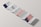 A minimalist design of a folded brochure mockup is displayed against a light background. The sequence of panels shows varied typography and graphics, with a mix of dark blue, white, and peach colors. Some panels contain textual content, while one has an abstract image resembling a mountain with a gradient sky.