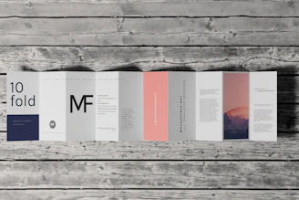 Colorful brochures and flyers spread out on a wooden desk.