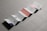 An accordion-style brochure is laid out on a textured surface. The brochure consists of multiple panels with a minimalist design, featuring text and some graphical elements in muted colors. Each panel displays different content, with some having bold letters and others displaying paragraphs of text.
