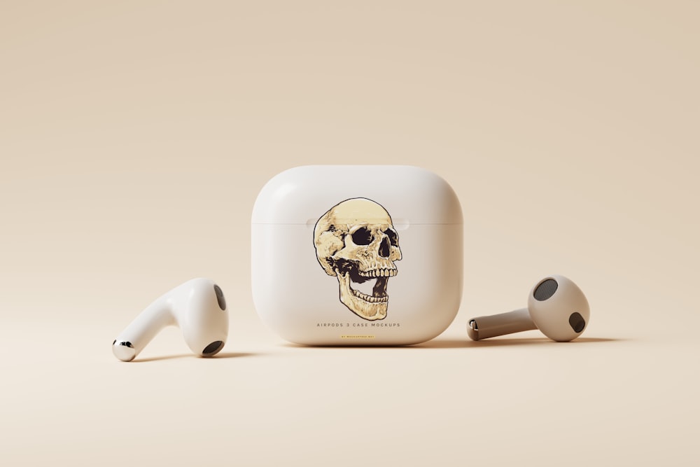 a pair of ear buds with a skull on it