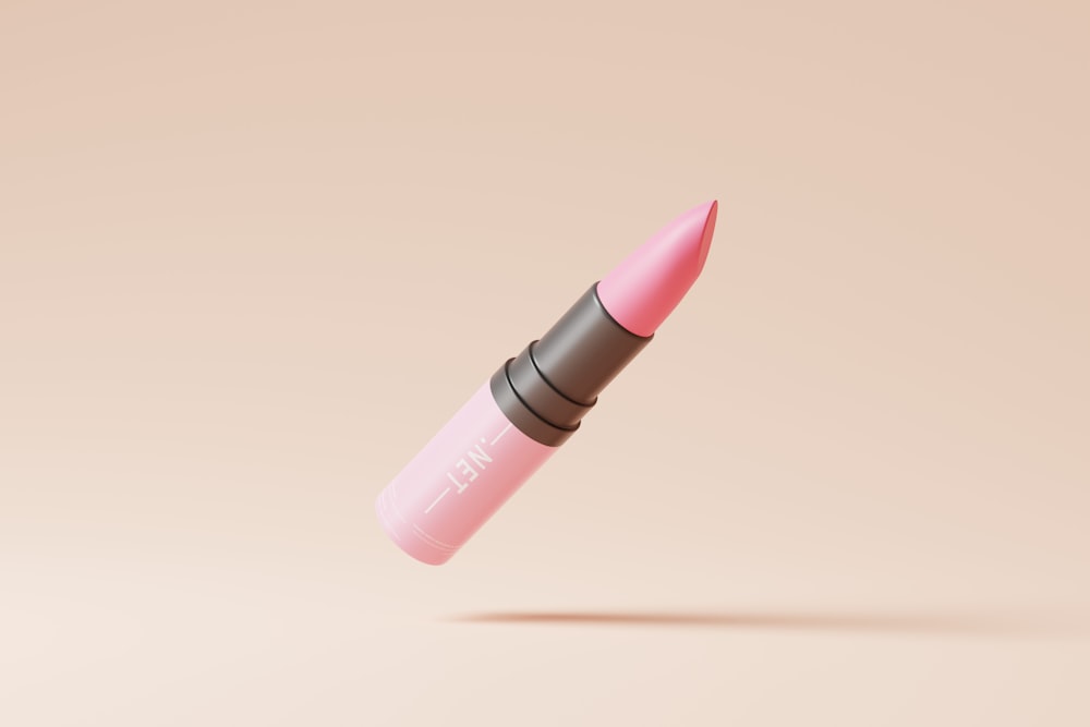 a pink lipstick with a black tip
