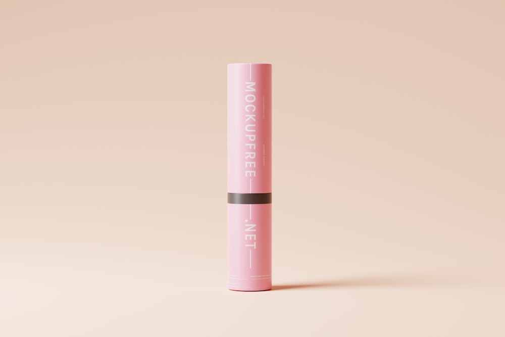 a pink lip bale sitting on top of a pink surface