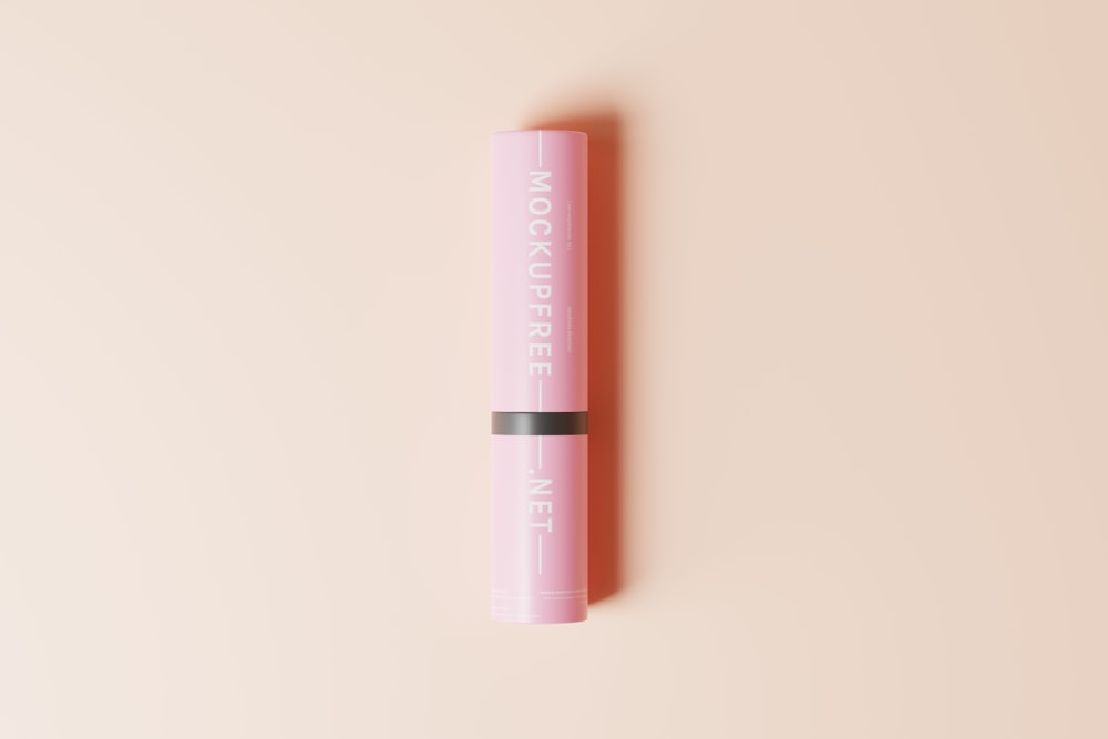 a pink lip bale sitting on top of a pink surface
