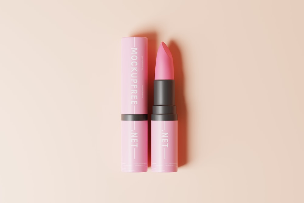 two pink lipsticks sitting next to each other
