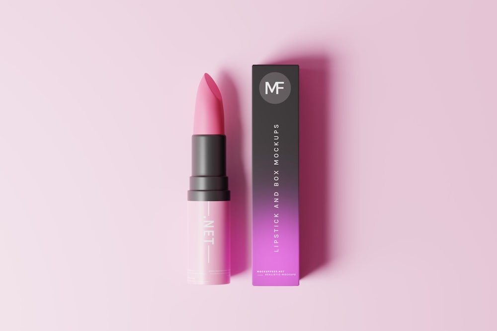 a pink lipstick sitting next to a box of lipstick