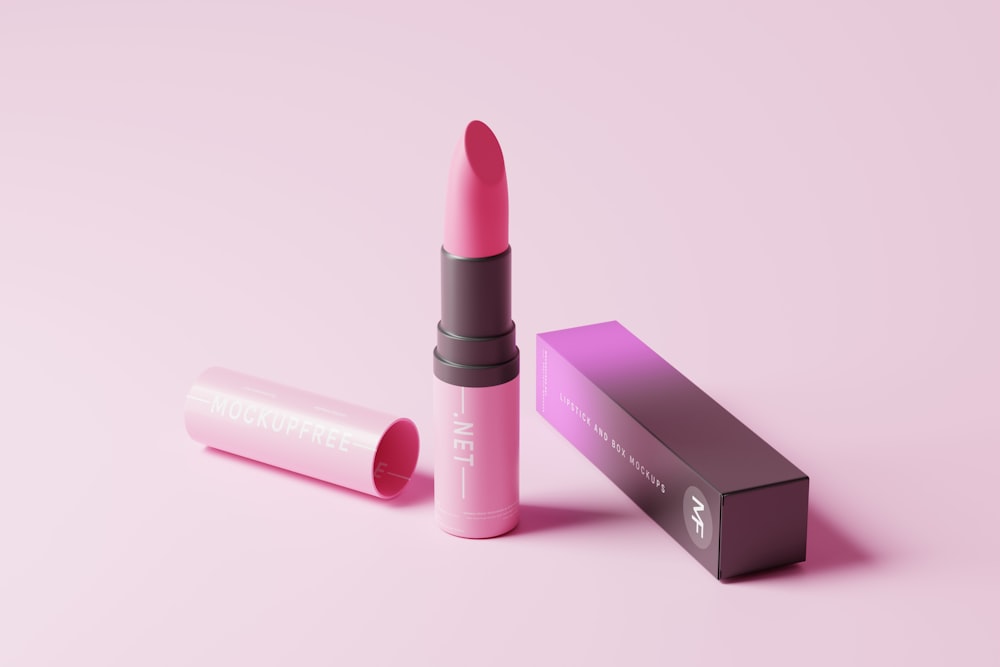 a pink lipstick is next to a pink box