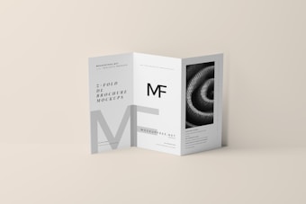 A tri-fold DL brochure mockup on a beige background. The brochure features modern typography and geometric design elements, with one panel displaying a black-and-white image of a spiral pattern. The brochure text includes a prominent 'MF' logo.