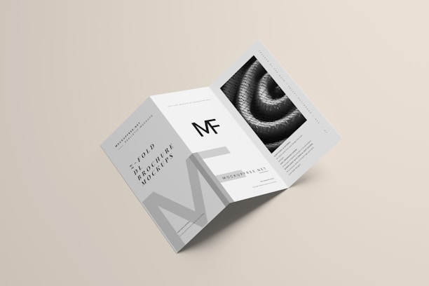 A modern, minimalist trifold brochure mockup that includes clean lines and a monochromatic color scheme. It features text elements and a textured image on one of its panels.