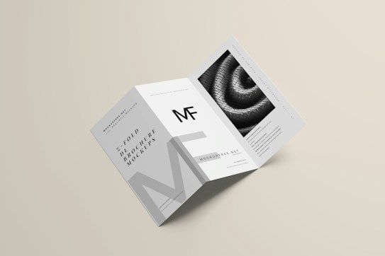 A modern, minimalist trifold brochure mockup that includes clean lines and a monochromatic color scheme. It features text elements and a textured image on one of its panels.