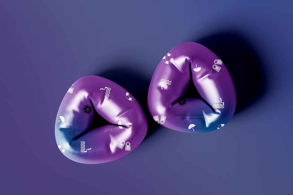 two purple inflatable objects on a purple background