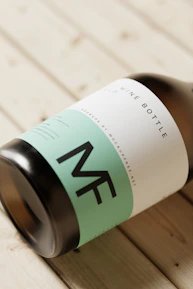 a bottle of wine sitting on top of a wooden table