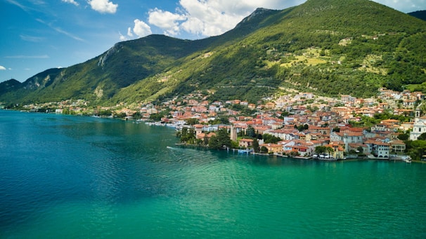 an aerial view of a small town on the shore of a lake