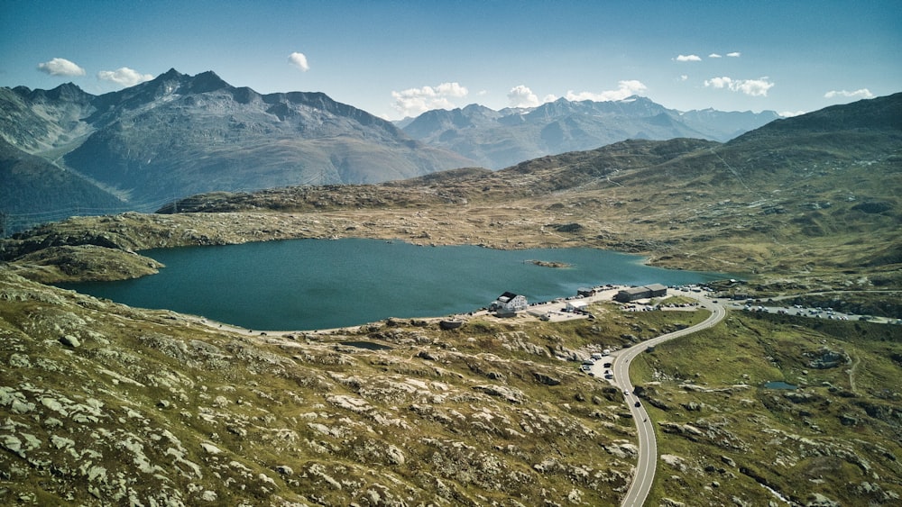 an aerial view of a mountain lake surrounded by mountains