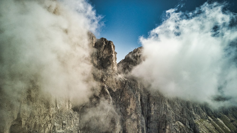 a very tall mountain with some very pretty clouds