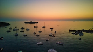 a group of boats floating on top of a body of water