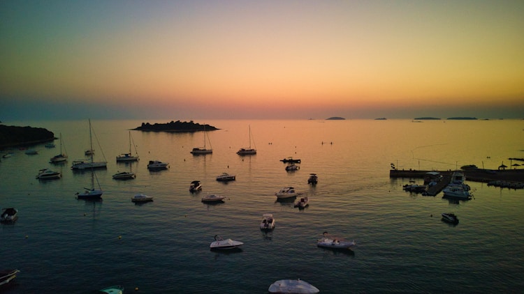 a group of boats floating on top of a body of water