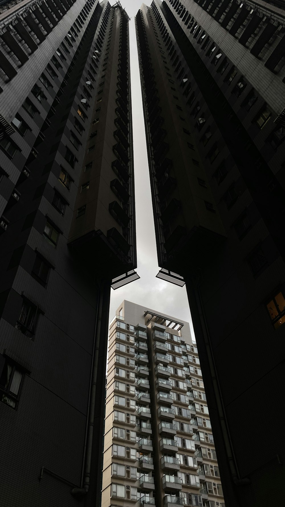 two tall buildings are seen from the ground