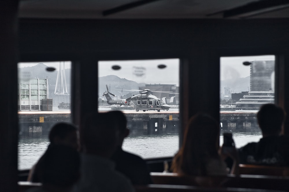 a group of people sitting in front of a window