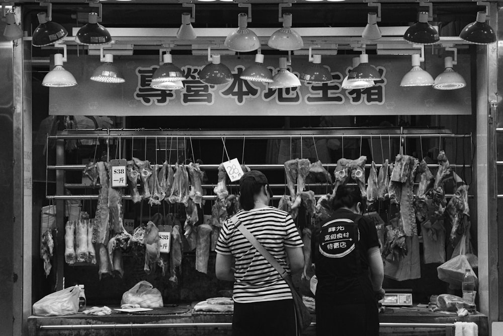 a couple of people standing in front of a store