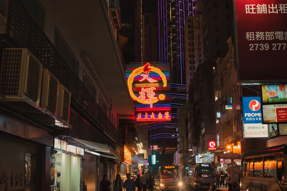 a busy city street at night with neon signs