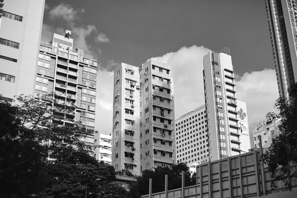 a black and white photo of tall buildings