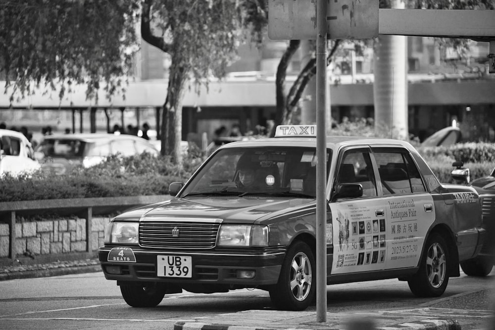 a black and white photo of a taxi cab