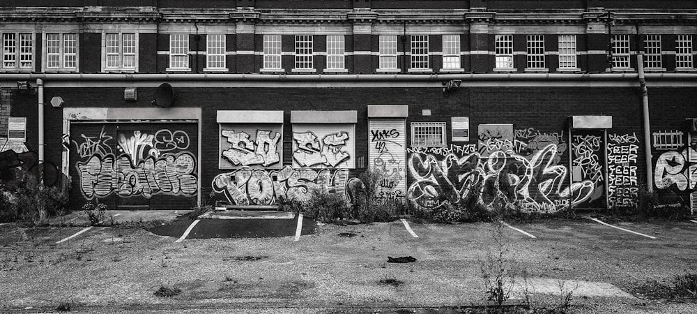 a black and white photo of a building with graffiti on it