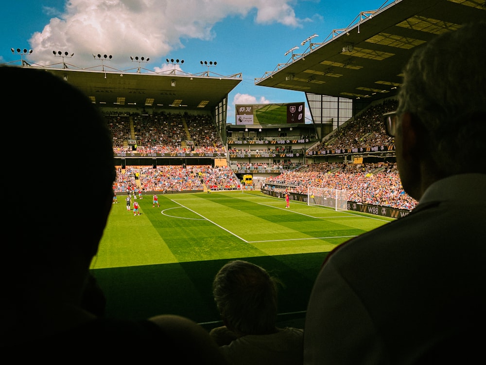 a group of people watching a soccer game