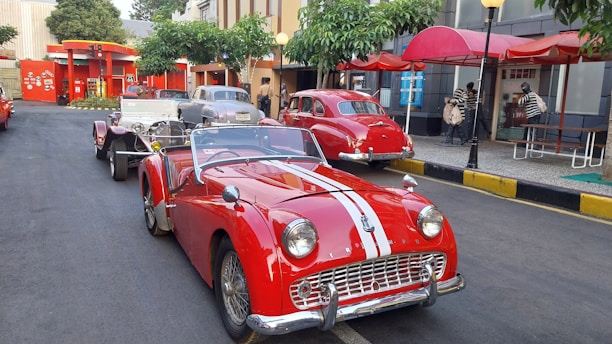 A vibrant street scene in Havana with colorful classic cars and lively local people.