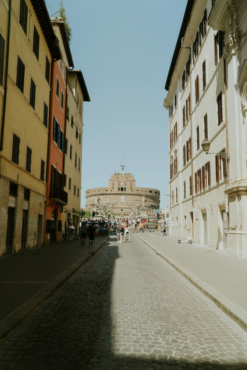 a cobblestone street lined with tall buildings