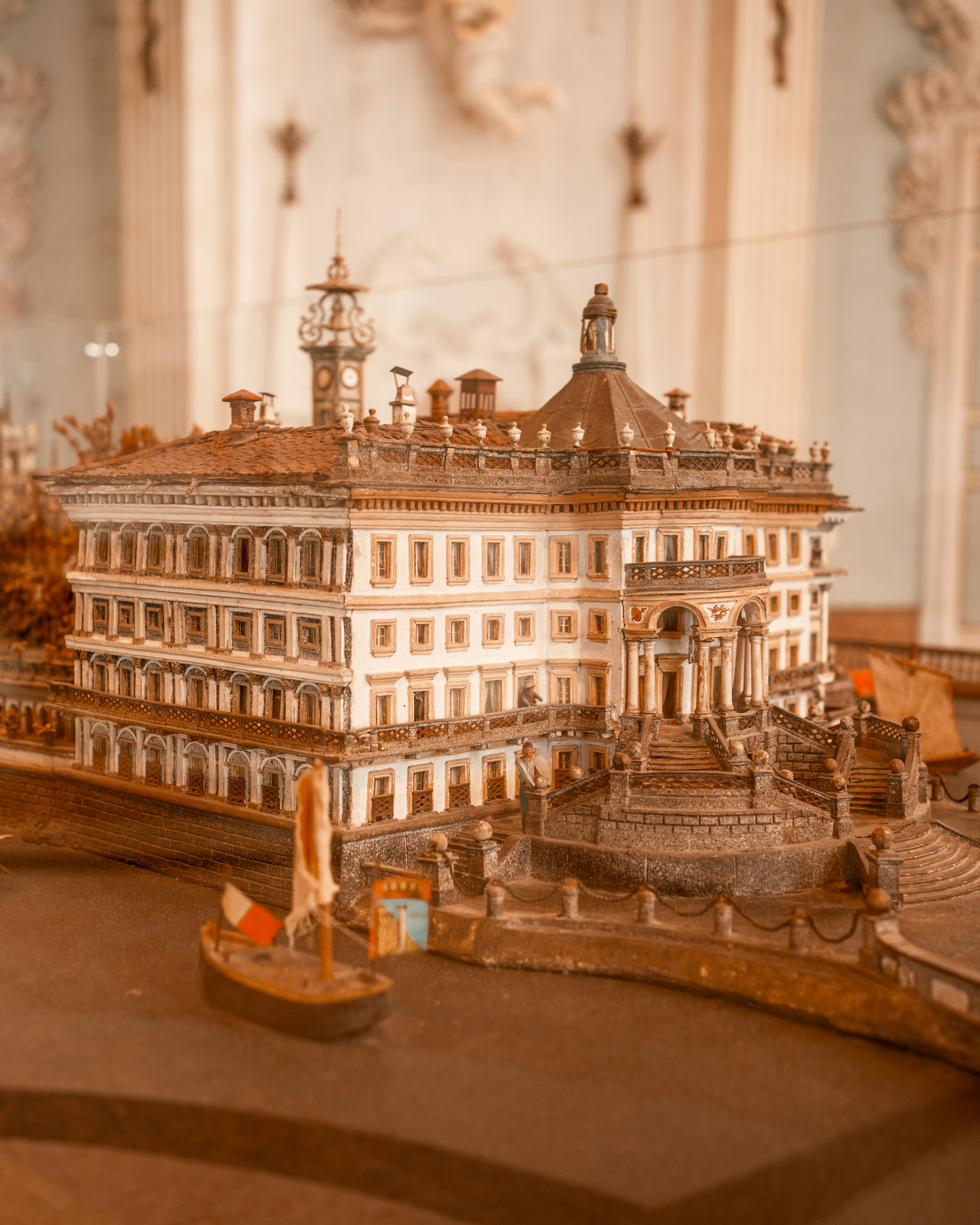 a model of a building with a boat in front of it