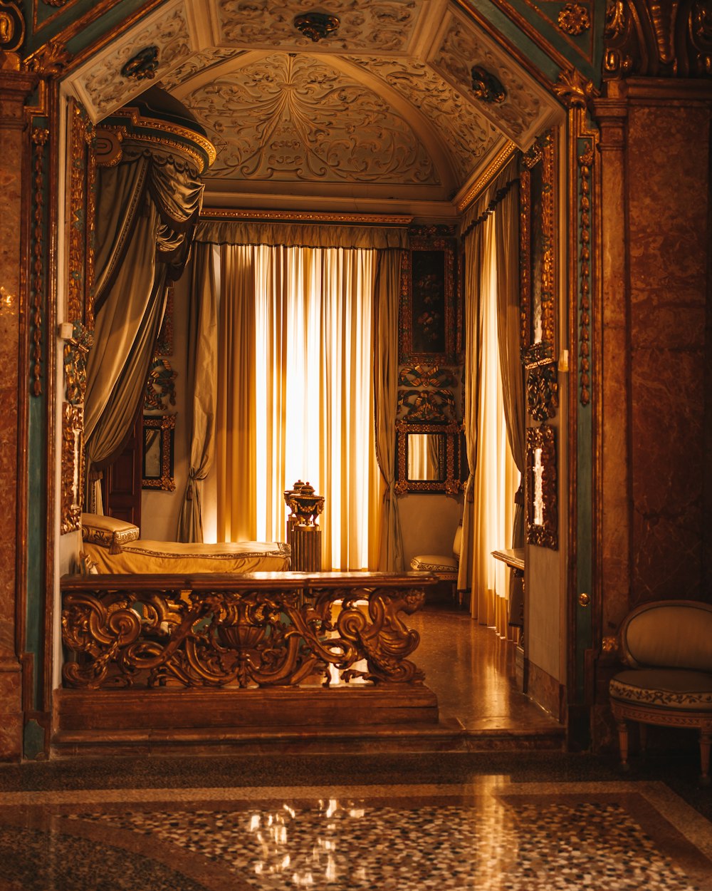 a fancy bedroom with a canopy bed and a chandelier