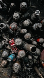 A collection of various car parts displayed on a workshop table.