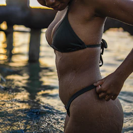 a woman in a bikini standing in the water