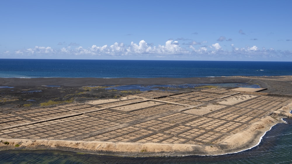 an aerial view of a farm in the middle of the ocean