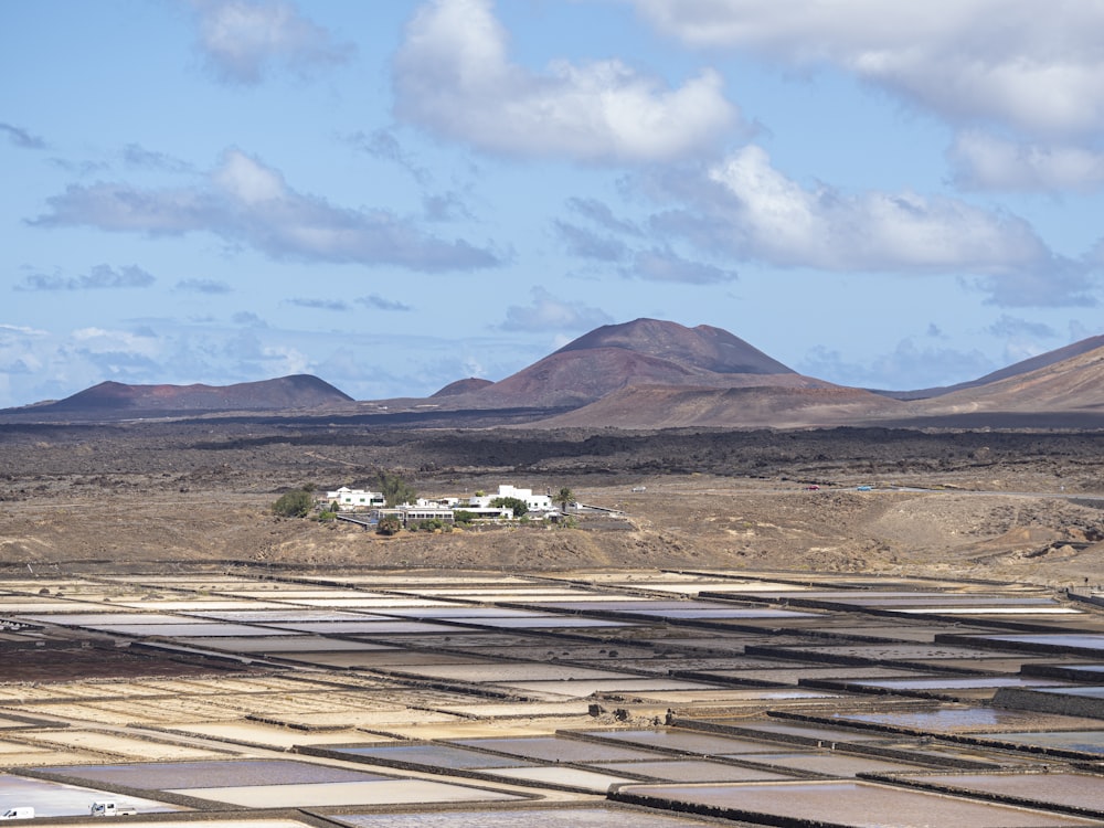 a large field with mountains in the background