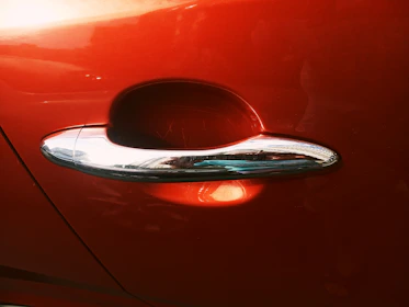 Side-by-side comparison of a car door before and after paint correction, highlighting restored shine.