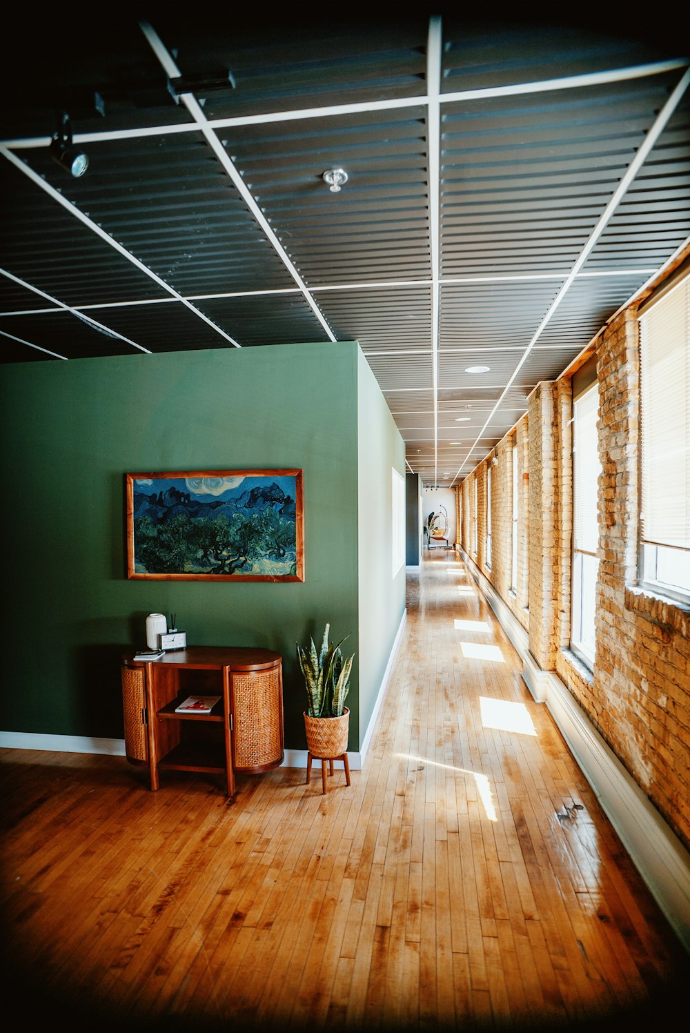 a room with a wooden floor and a painting on the wall