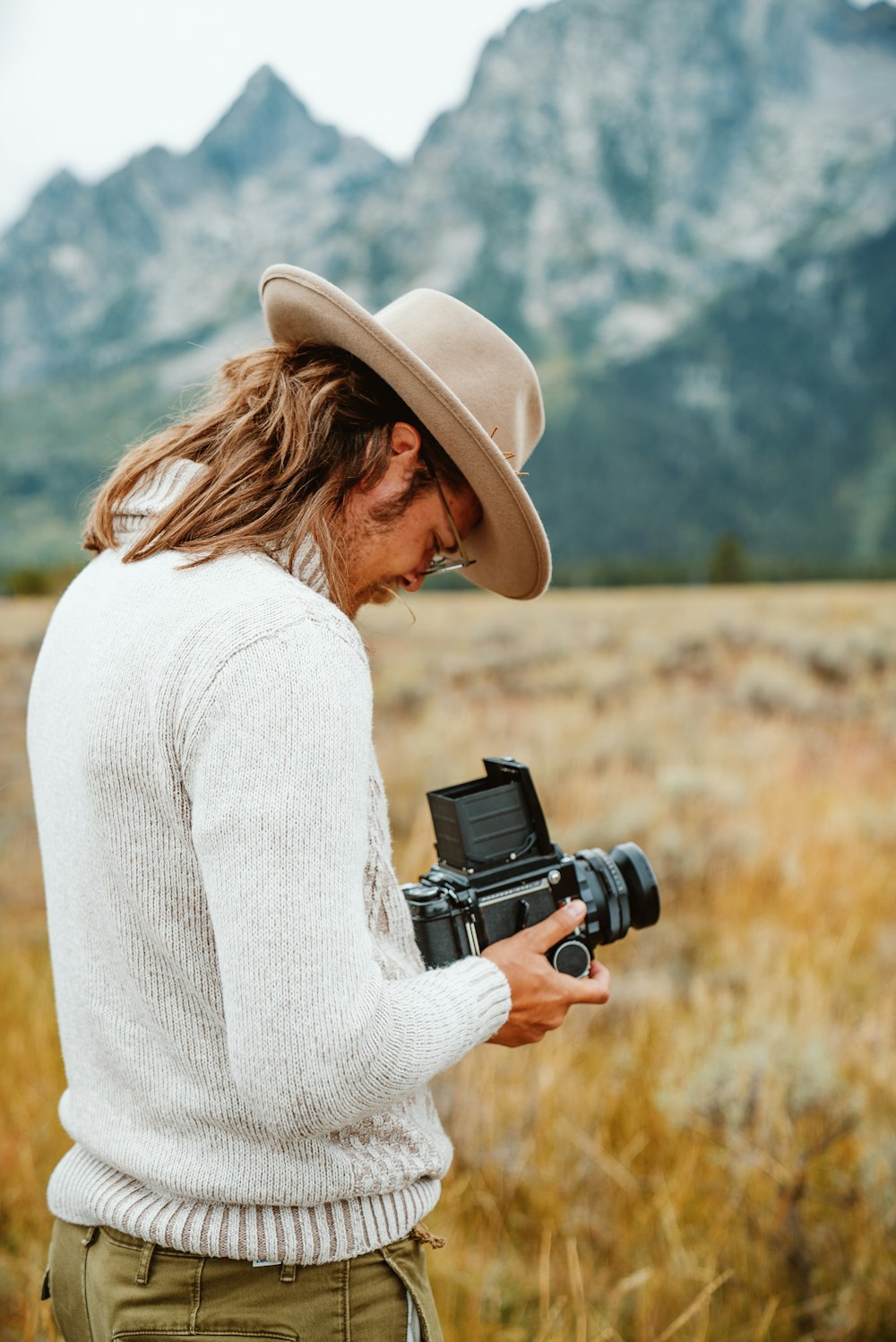 a man with long hair holding a camera