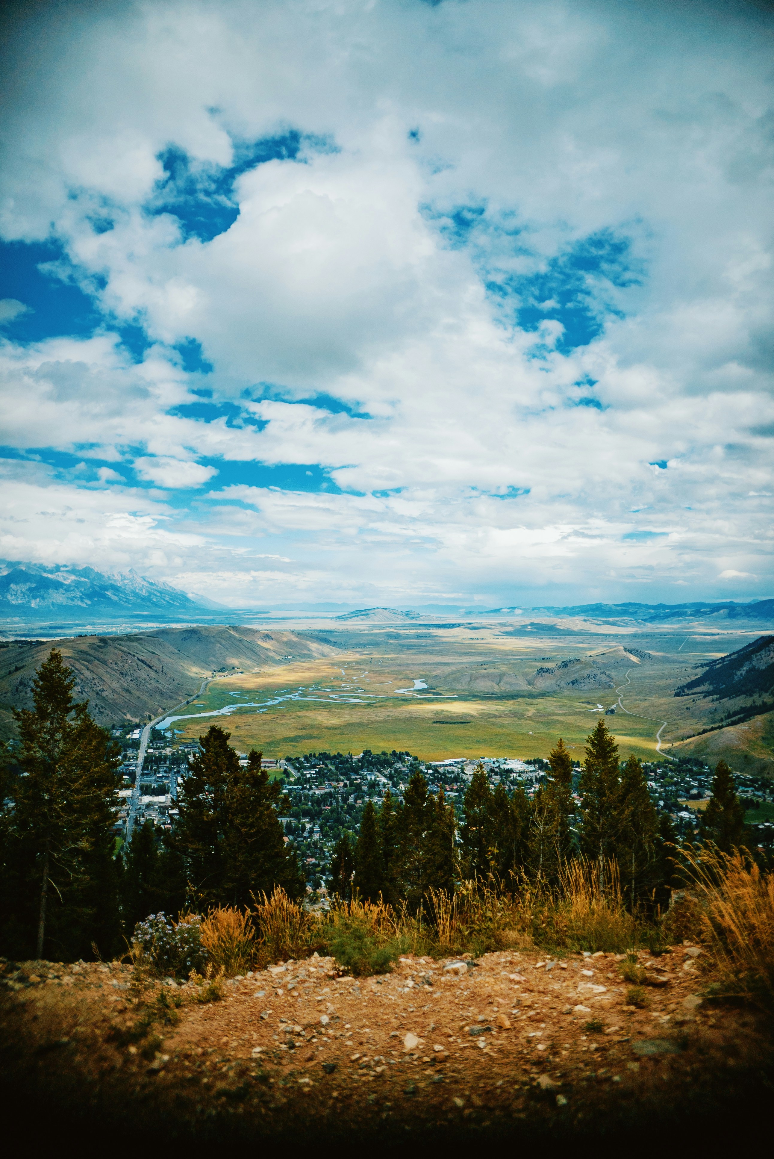 a scenic view of a town and a valley