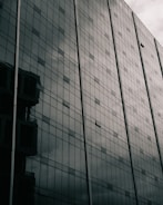 Close-up of a high-rise residential tower with glass facades reflecting the sky.